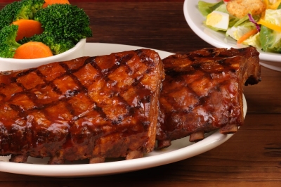 Full Slab of fall-off-the-bone pork ribs glazed with BBQ sauce at Texas Roadhouse
